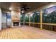 Cozy covered deck with a stone fireplace, offering a perfect outdoor space for relaxation and entertainment at 6750 Pannell Rd, Buford, GA 30518