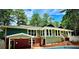 Exterior view of back of home with brick foundation and in-ground swimming pool at 1516 Chase Ct, Riverdale, GA 30296