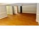 Spacious basement area with hardwood floors and neutral wall colors, ready for customization at 1516 Chase Ct, Riverdale, GA 30296