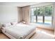 Bright bedroom with a large window, offering a view of the backyard and in-ground pool at 1516 Chase Ct, Riverdale, GA 30296