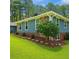 Landscaped yard with a blue home in the background at 1516 Chase Ct, Riverdale, GA 30296