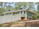 Side view of a home with a white fence, green siding and a well-kept lawn at 1516 Chase Ct, Riverdale, GA 30296