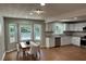Open concept kitchen with a dining area, white cabinetry, and stainless steel appliances at 1516 Chase Ct, Riverdale, GA 30296