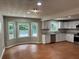 Open concept kitchen with a dining area, white cabinetry, and stainless steel appliances at 1516 Chase Ct, Riverdale, GA 30296