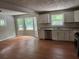 Open concept kitchen with white cabinetry and stainless steel appliances at 1516 Chase Ct, Riverdale, GA 30296