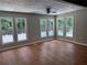 Bright, open room with large windows offering serene backyard views, and beautiful wood flooring at 1516 Chase Ct, Riverdale, GA 30296