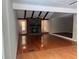 Open concept living room with hardwood floors and a striking stone fireplace at 1516 Chase Ct, Riverdale, GA 30296
