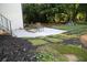 Landscaped backyard features a stone patio and a walkway with integrated planting features at 3199 Nw Delmar Ln, Atlanta, GA 30311