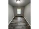 A bare room with wood-look floors and light gray walls features a single window at 3199 Nw Delmar Ln, Atlanta, GA 30311