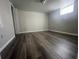Empty room shows off updated flooring, fresh paint, modern lighting and a window offering natural light at 3199 Nw Delmar Ln, Atlanta, GA 30311