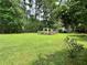 Spacious backyard featuring a well-maintained lawn and a charming fenced garden at 4114 Falcon Shores Nw Ct, Acworth, GA 30101