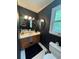 Well-lit bathroom with a vanity, an oval mirror, and ample storage space at 4114 Falcon Shores Nw Ct, Acworth, GA 30101