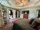 Lovely bedroom featuring a tray ceiling, a comfortable bed, and easy access to bathroom and closet at 4114 Falcon Shores Nw Ct, Acworth, GA 30101