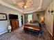 Cozy bedroom featuring a tray ceiling, bench seating, and ample closet space at 4114 Falcon Shores Nw Ct, Acworth, GA 30101