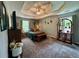Relaxing bedroom with a tray ceiling, a comfortable bed, and peaceful decor at 4114 Falcon Shores Nw Ct, Acworth, GA 30101