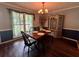 Bright dining room with backyard view, decorative hutch and chandelier at 4114 Falcon Shores Nw Ct, Acworth, GA 30101