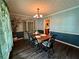 Charming dining room with wood table, wainscoting, and decorative lighting at 4114 Falcon Shores Nw Ct, Acworth, GA 30101