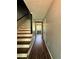 Hallway with wooden floors leading to a dining room with seating for six at 4114 Falcon Shores Nw Ct, Acworth, GA 30101
