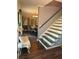 Hallway with wooden floors leading to a dining room with seating for six at 4114 Falcon Shores Nw Ct, Acworth, GA 30101
