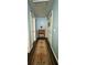 Charming hallway features hardwood floors, a stylish runner rug, and blue painted walls at 4114 Falcon Shores Nw Ct, Acworth, GA 30101