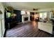 Spacious living room features a brick fireplace, dark accent wall, and wood-look floors at 4114 Falcon Shores Nw Ct, Acworth, GA 30101