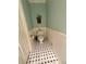 Charming powder room featuring wainscoting and a classic black and white tile floor at 4114 Falcon Shores Nw Ct, Acworth, GA 30101