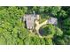 Aerial view of the house showing the layout with a long driveway and surrounded by mature trees at 654 Cannon Rd, Sharpsburg, GA 30277