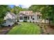 A lush green backyard with a deck, a covered porch, and a shed offers ample outdoor space at 654 Cannon Rd, Sharpsburg, GA 30277