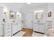 Well-lit bathroom features double sinks, stylish mirrors, modern fixtures, and lots of storage in bright white at 654 Cannon Rd, Sharpsburg, GA 30277