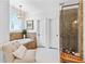 Bathroom featuring soaking tub, walk-in shower, vanity area, natural lighting and two large closet areas at 654 Cannon Rd, Sharpsburg, GA 30277