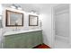 Stylish bathroom boasts a double vanity, wood framed mirrors, and a tiled shower at 654 Cannon Rd, Sharpsburg, GA 30277