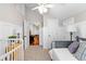 Cozy bedroom with detailed paneling and views to another room, featuring soft carpet and vintage furnishings at 654 Cannon Rd, Sharpsburg, GA 30277