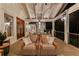 Relaxing covered deck with comfortable seating, decor lighting, and wooded views at 654 Cannon Rd, Sharpsburg, GA 30277