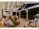 Relaxing covered deck featuring comfortable seating, decor lighting, and wooded views at 654 Cannon Rd, Sharpsburg, GA 30277