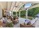 A covered porch with outdoor seating and a ceiling fan offers a relaxing space with views of the wooded landscape at 654 Cannon Rd, Sharpsburg, GA 30277