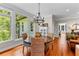 Cozy dining area with hardwood floors, a round table, wicker chairs, and natural light at 654 Cannon Rd, Sharpsburg, GA 30277