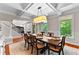 Formal dining room offering an elegant chandelier, large windows, and seamless flow into the living space at 654 Cannon Rd, Sharpsburg, GA 30277