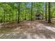 Charming exterior view of a rustic cabin nestled in a serene wooded setting at 654 Cannon Rd, Sharpsburg, GA 30277
