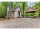 Charming home exterior with a carport, nestled in a wooded setting, offering privacy and a rustic appeal at 654 Cannon Rd, Sharpsburg, GA 30277