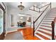 Staircase beside formal dining area featuring elegant wainscoting, coffered ceiling, and abundant natural light at 654 Cannon Rd, Sharpsburg, GA 30277