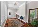 Inviting foyer with hardwood floors, decorative rug, accent seating, and sidelight windows at 654 Cannon Rd, Sharpsburg, GA 30277