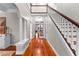 Grand foyer with staircase, leading to hallways with architectural columns and french doors, offering a sense of arrival at 654 Cannon Rd, Sharpsburg, GA 30277