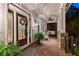 Inviting front porch features stained-glass entry, brick flooring, rocking chairs, and a porch swing at 654 Cannon Rd, Sharpsburg, GA 30277