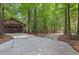 Detached garage with ample parking and wooded surroundings, offering privacy and convenience at 654 Cannon Rd, Sharpsburg, GA 30277