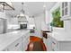 Modern kitchen featuring white cabinets, a center island, and a copper sink beneath a window at 654 Cannon Rd, Sharpsburg, GA 30277