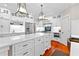 Bright kitchen with white cabinets, quartz countertops, stainless steel appliances, and center island at 654 Cannon Rd, Sharpsburg, GA 30277