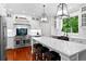 Bright kitchen with white cabinetry, quartz counters, large island, and pendant lighting at 654 Cannon Rd, Sharpsburg, GA 30277