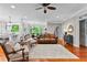 Inviting living room featuring hardwood floors, a ceiling fan and traditional-style furnishings at 654 Cannon Rd, Sharpsburg, GA 30277