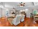 Spacious living room features hardwood floors, two sofas, decorative rug, ceiling fans, and access to an office at 654 Cannon Rd, Sharpsburg, GA 30277