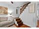 Cozy living room with a staircase and scripture wall art, creating a unique and inviting space at 654 Cannon Rd, Sharpsburg, GA 30277